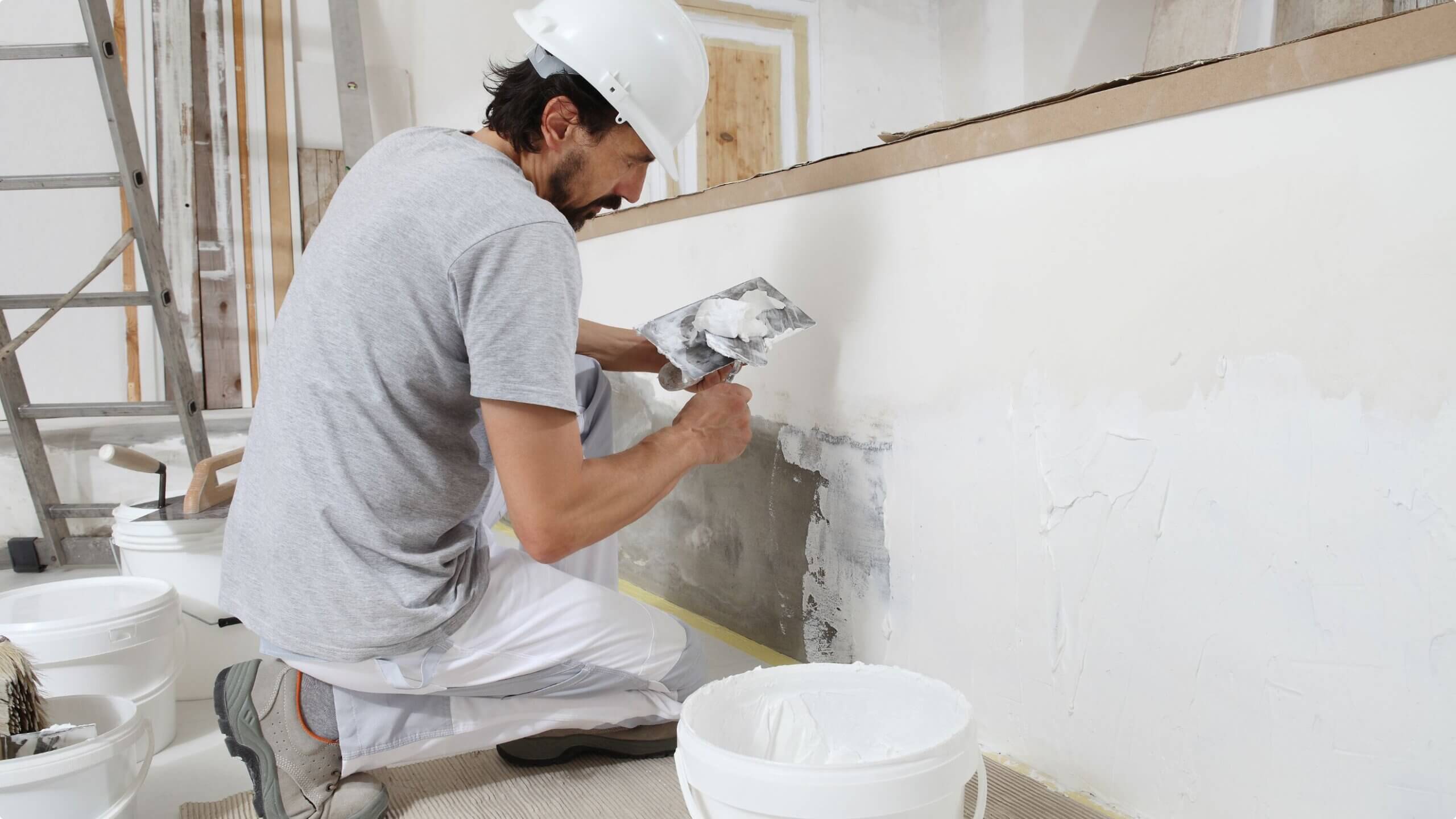 Sunset Coatings crew applying plaster to a Tucson stucco wall